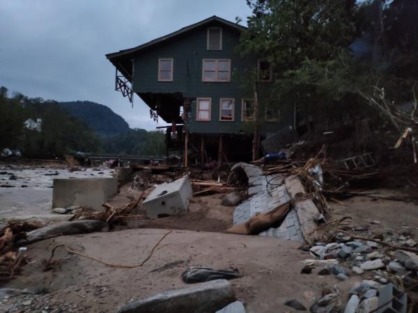 Damaged homes and roads in Bat Cave after the region was hit by Helene.